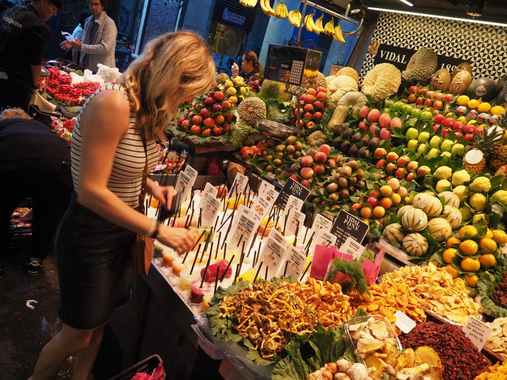 TOP 10 THINGS TO DO IN BARCELONA featured by top Missouri travel blogger, Emmy Lou Styles: Visit the Mercat de la Boqueria in Barcelona to find fresh juices, fruit, desserts and more.