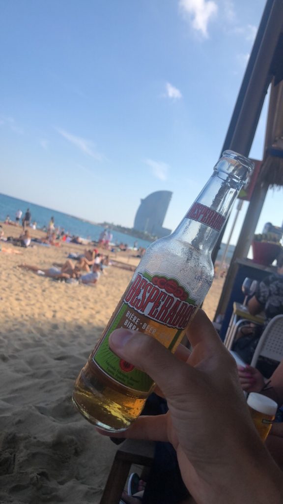 TOP 10 THINGS TO DO IN BARCELONA featured by top Missouri travel blogger, Emmy Lou Styles: Visit the public beach in Barcelona and have a beer