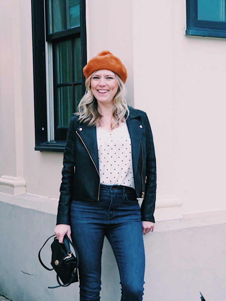 Emily from Emmy Lou Styles shares how she styles the Madewell beret from Nordstrom. | Orange Madewell beret styled by top US fashion blogger, Emmy Lou Styles: image of a woman wearing an orange beret from Madewell, leather jacket, polka dot shirt, Sole Society cross body bag, J Crew jeans, Sam Edelman red booties