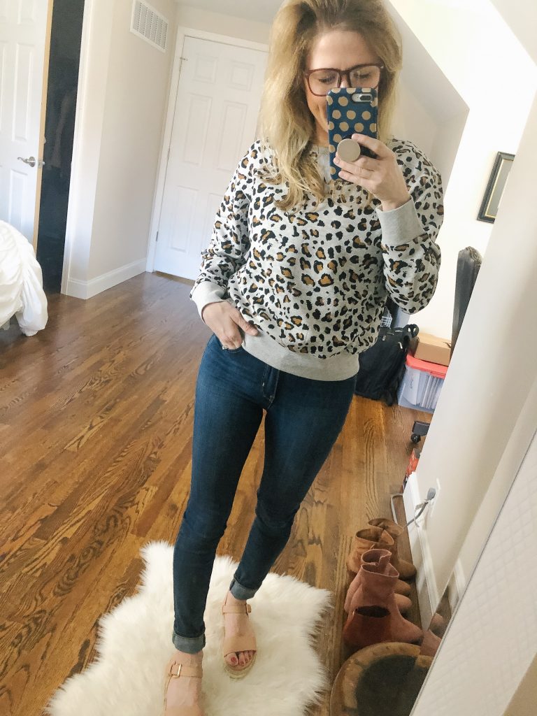 H&M Gray Leopard Print sweatshirt; image of woman wearing leopard print sweatshirt in front of mirror.