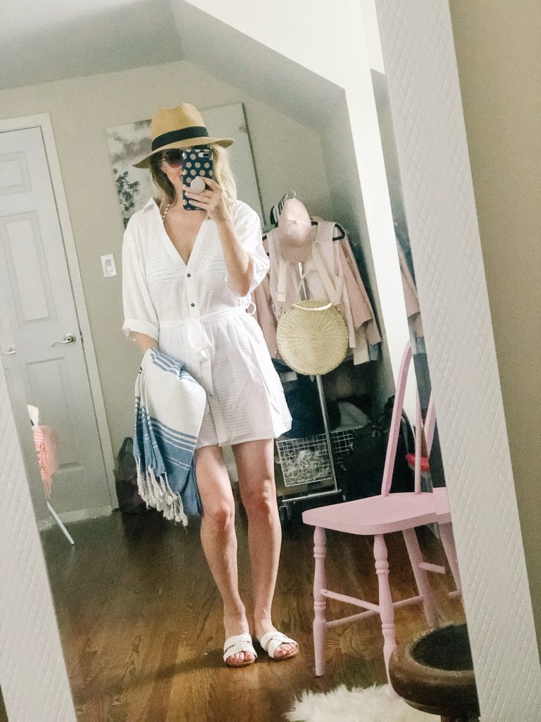 Woman wearing white button up swim cover up