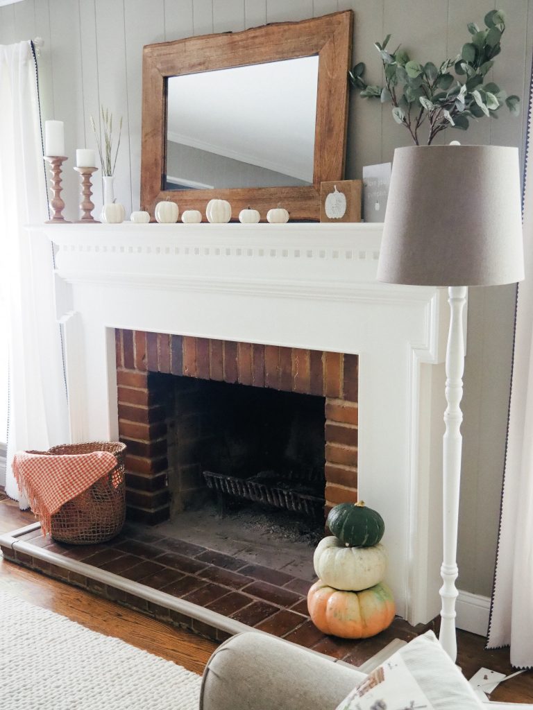 Easy fall mantle decor with a basket and orange blanket