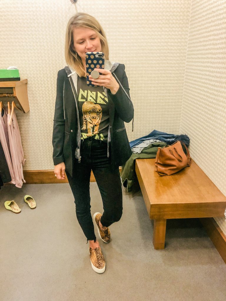 Woman wearing graphic tee and fitted blazer from Evereve standing in front of mirror