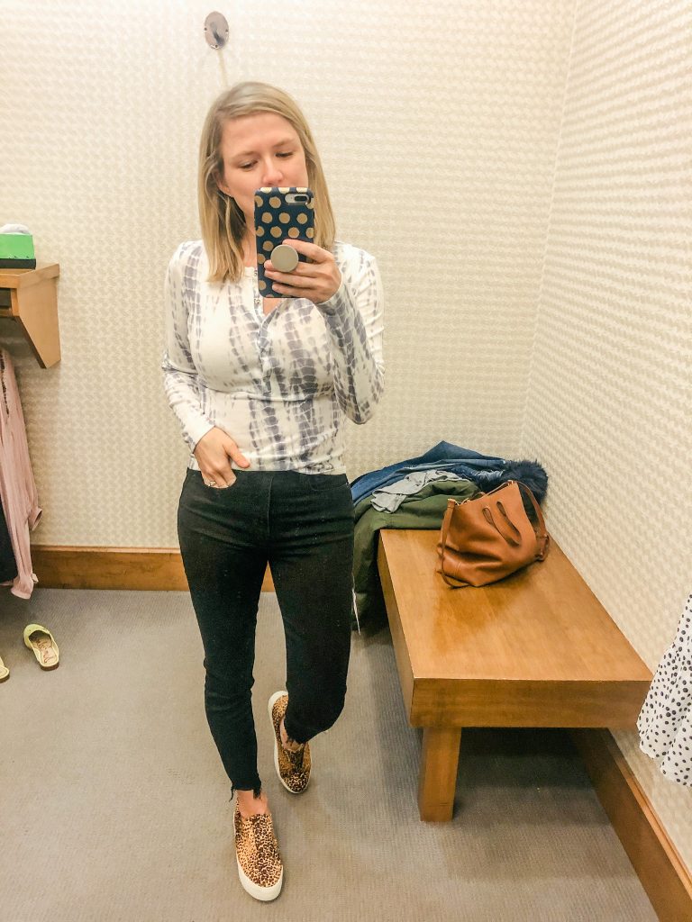 Woman wearing tie dye tee from Evereve new arrivals standing in front of mirror